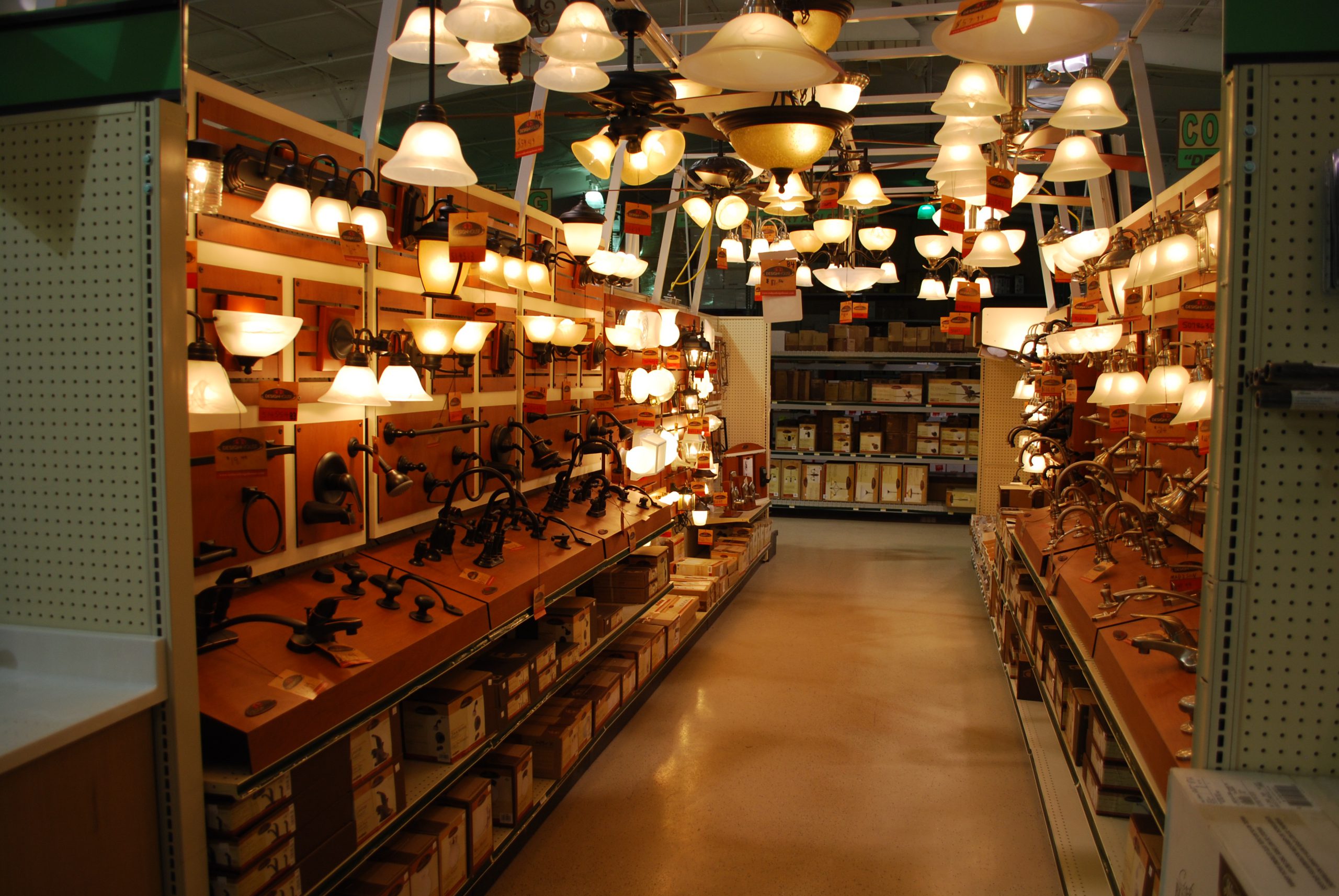 Hardware store aisle with light fixtures and product promotion