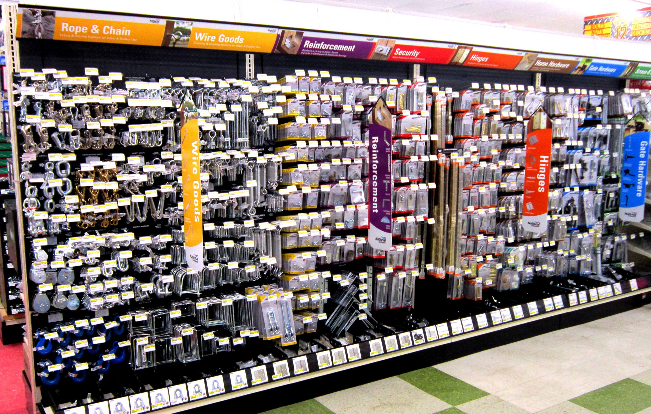 Hardware store aisle with House-Hasson bin-tagged products 